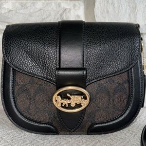Coach Georgie Saddle bag—a small purse. Black and brown, classic C coach design.